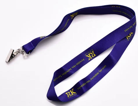 Flat metal clip fastener securing the end of a satin event wristband